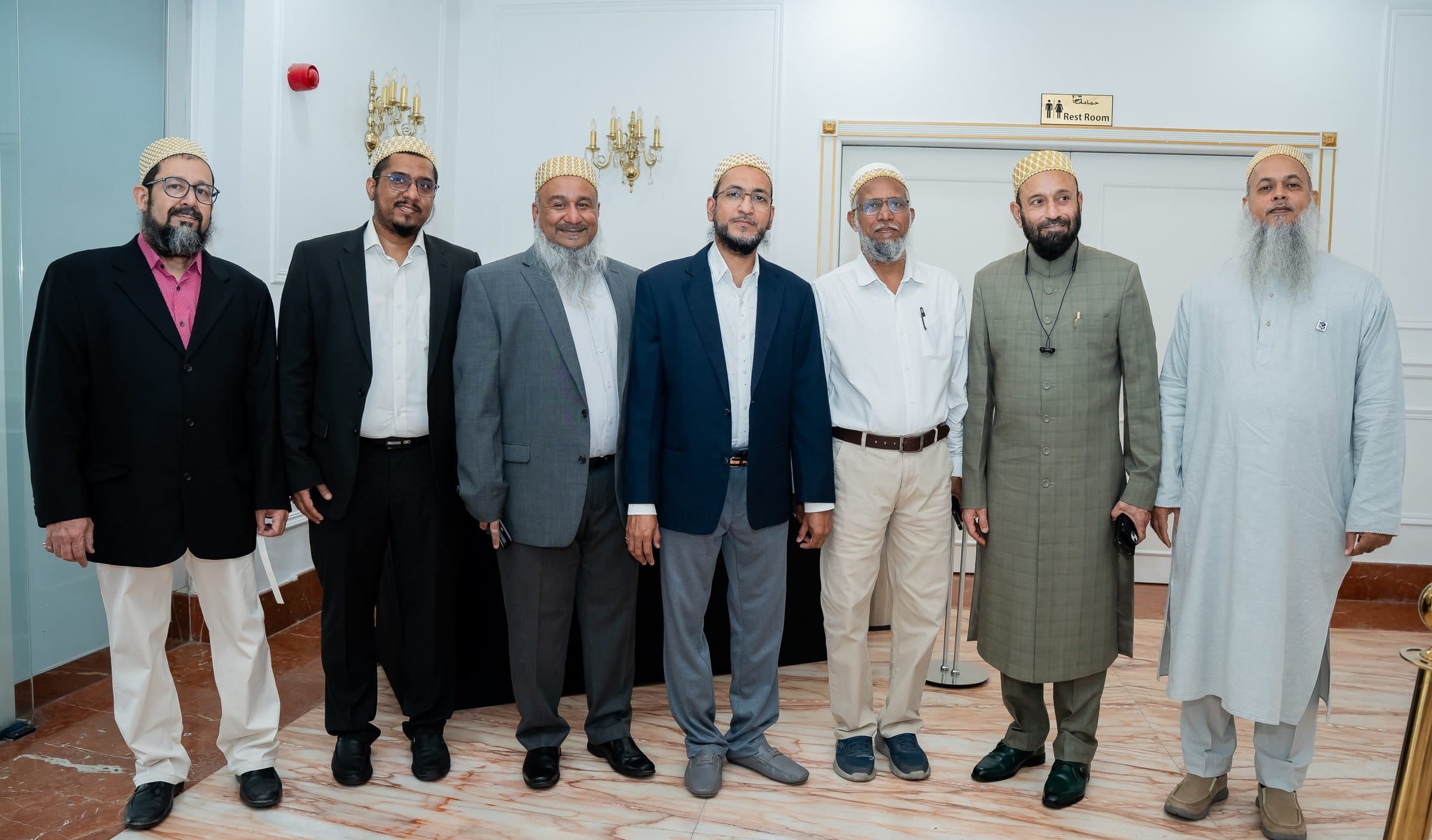 Group of ten men standing together in a hotel function room